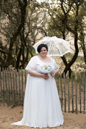 Une robe de mariée élégante en mousseline fluide, délicatement ornée de dentelle, conçue pour sublimer toutes les silhouettes avec grâce et confort